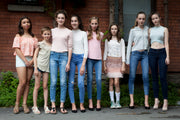 group of teen girls posing for the camera dress in fashion outfits
